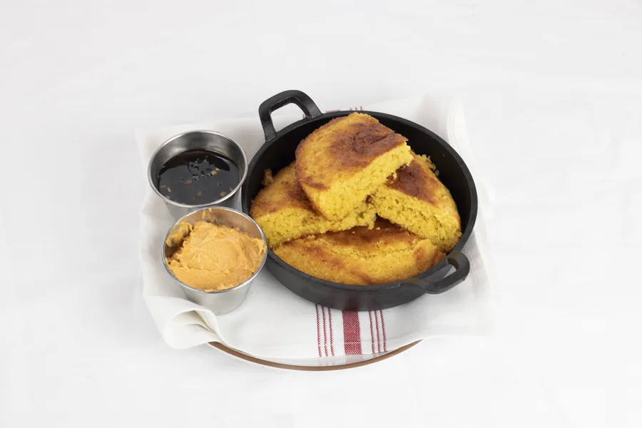 Cornbread baked and served in a cast-iron skillet